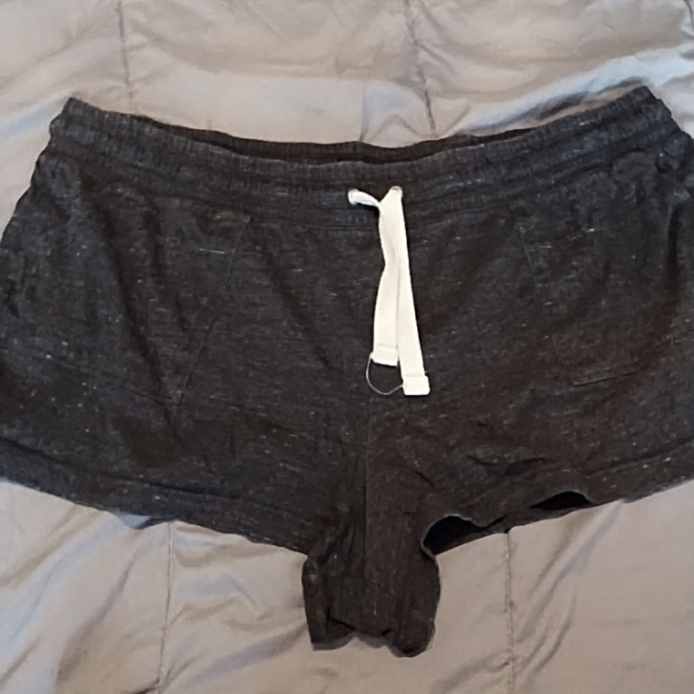 Grey sleep shorts with front pockets and a drawstring